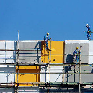 Construction workers on a scaffold,building a site.