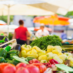 Farmers’ market stall displaying a variety of organic vegetables.