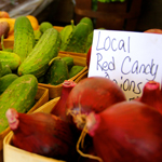 A variety of locally grown organic farmer's market vegetables are on display for sale.