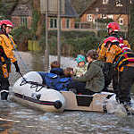 Family being rescued by the fire service after the River Derwent burst it's banks in the village of Old Malton England. 