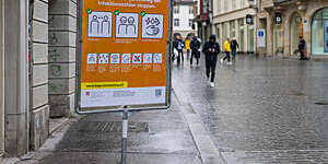 A large sign in the city centre of St Gallen, Switzerland, reminds people how to behave during the COVID-19 pandemic.