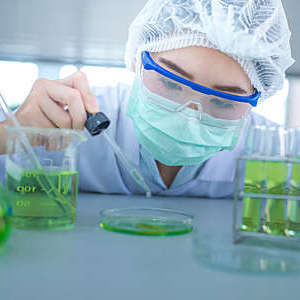Close-up of a female scientist experimenting in a laboratory.